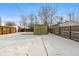 Snowy backyard with a storage shed and wooden fence at 4518 Vallejo St, Denver, CO 80211