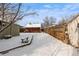 Large, snowy backyard with a storage shed and wooden fence offering privacy at 4518 Vallejo St, Denver, CO 80211