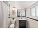 Stylish bathroom features white subway tile, black vanity, and updated fixtures at 4518 Vallejo St, Denver, CO 80211