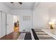 Sunlit bedroom with hardwood floors, minimalist furnishings, and a doorway, creating a serene space at 4518 Vallejo St, Denver, CO 80211