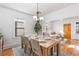 Dining room open to the living room featuring a wooden table setting, perfect for Gathering meals at 4518 Vallejo St, Denver, CO 80211