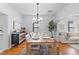 Well-lit dining area showcases a wooden table and views into living room, perfect for entertaining at 4518 Vallejo St, Denver, CO 80211