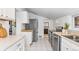 Bright kitchen features white cabinets, stainless steel appliances, and tile floors at 4518 Vallejo St, Denver, CO 80211