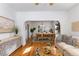 Inviting living room and dining room area features hardwood floors, tasteful decor, and plenty of natural light at 4518 Vallejo St, Denver, CO 80211