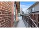 A side view of the brick house with a door leading to the snowy backyard at 4518 Vallejo St, Denver, CO 80211