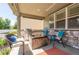 Covered back patio featuring a built-in grill, a fire pit, and comfortable seating at 190 Olympia Ave, Longmont, CO 80504