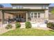 Backyard view with a covered patio, a stone-accented wall and some garden boxes at 190 Olympia Ave, Longmont, CO 80504