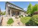 Backyard view with a covered patio, a well-maintained lawn, and mature landscaping at 190 Olympia Ave, Longmont, CO 80504