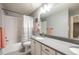 Bathroom featuring a double vanity, large mirror, and shower over tub at 190 Olympia Ave, Longmont, CO 80504