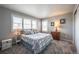 Cozy bedroom featuring large windows with shutters, a comfortable bed, and classic decor at 190 Olympia Ave, Longmont, CO 80504
