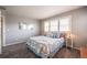 Bright bedroom showcases shuttered windows, a comfortable bed, and neutral decor at 190 Olympia Ave, Longmont, CO 80504
