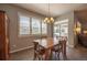 Dining room featuring a wood dining table, light fixture, and large windows with shutters at 190 Olympia Ave, Longmont, CO 80504