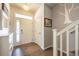 Bright foyer featuring hardwood floors, a front door with sidelights, and staircase with white railing at 190 Olympia Ave, Longmont, CO 80504