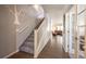 Inviting foyer with hardwood floors, staircase and open view to the living area at 190 Olympia Ave, Longmont, CO 80504