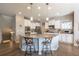 Bright kitchen featuring a large island, stainless steel appliances, white cabinetry and hardwood floors at 190 Olympia Ave, Longmont, CO 80504