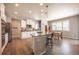 Modern kitchen with white cabinets, stainless steel appliances, and an island with a breakfast bar at 190 Olympia Ave, Longmont, CO 80504