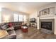 Comfortable living room with a cozy fireplace, hardwood floors, and a large sectional sofa at 190 Olympia Ave, Longmont, CO 80504