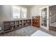 Office with gray carpet, ample shelving, and a bright window overlooking the exterior at 190 Olympia Ave, Longmont, CO 80504