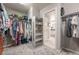 Spacious walk-in closet features ample storage and shelving for clothing and accessories with an open door to the bathroom at 190 Olympia Ave, Longmont, CO 80504