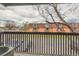 Balcony view looking out to the community with mature landscaping, parking, and brick exteriors at 6388 Oak Ct # 203, Arvada, CO 80004
