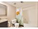 Bathroom featuring a shower with mountain curtain, white toilet, vanity with granite countertop, and mirror at 6388 Oak Ct # 203, Arvada, CO 80004