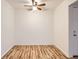A bright bedroom with wood floors and ceiling fan features a spacious and clean layout at 6388 Oak Ct # 203, Arvada, CO 80004