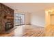 Cozy living room featuring a rock fireplace, sliding glass doors and modern flooring at 6388 Oak Ct # 203, Arvada, CO 80004