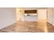 Spacious living room with wood laminate flooring and views to the kitchen and exterior at 6388 Oak Ct # 203, Arvada, CO 80004
