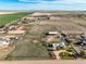 Wide aerial view of a house and large barn in an agricultural area with views to the horizon at 29881 E 128Th Ave, Commerce City, CO 80022