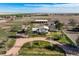 An aerial view shows the layout of the home and barn situated on the property with a circular gravel driveway at 29881 E 128Th Ave, Commerce City, CO 80022