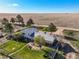 Elevated aerial shot of the backyard, home, and mature trees with farm land at 29881 E 128Th Ave, Commerce City, CO 80022
