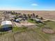 Aerial view of a property with farmland, house, and barn with a circular pen at 29881 E 128Th Ave, Commerce City, CO 80022