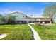 View of a well-manicured lawn and patio area with a covered grill and seating outside of the home's back entrance at 29881 E 128Th Ave, Commerce City, CO 80022