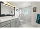 This bathroom has white marble walls, white cabinets, and a glass-enclosed shower stall at 29881 E 128Th Ave, Commerce City, CO 80022