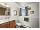 Classic bathroom with vanity, toilet, and natural light from the window at 29881 E 128Th Ave, Commerce City, CO 80022