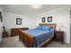 This bedroom features a wooden bed frame, matching nightstands, dressers and framed art at 29881 E 128Th Ave, Commerce City, CO 80022