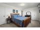 This bedroom features neutral carpeting, white walls, and a wood bed frame with blue comforter at 29881 E 128Th Ave, Commerce City, CO 80022