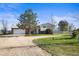 Charming home featuring a spacious front yard, long driveway and a combination of brick and vinyl siding at 29881 E 128Th Ave, Commerce City, CO 80022