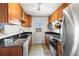 A kitchen features granite countertops, wooden cabinets, stainless steel appliances, and backyard access at 29881 E 128Th Ave, Commerce City, CO 80022