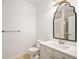 Bright bathroom featuring a sleek vanity with modern fixtures and a large, decorative mirror at 8358 S Independence Cir # 105, Littleton, CO 80128