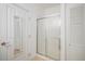 Clean bathroom with a glass-enclosed shower, a mirrored door, and white fixtures at 8358 S Independence Cir # 105, Littleton, CO 80128