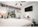 Inviting bedroom with a well-lit window showcasing plants, shelving, and a flat screen tv at 8358 S Independence Cir # 105, Littleton, CO 80128