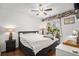 Comfortable bedroom with a cozy bed, a large window with decorative plant, and a ceiling fan at 8358 S Independence Cir # 105, Littleton, CO 80128