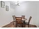 Cozy dining area features a round wooden table with seating for four and modern lighting at 8358 S Independence Cir # 105, Littleton, CO 80128