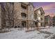 Inviting condo building with stone accents, balconies, and manicured landscaping, perfect for comfortable living at 8358 S Independence Cir # 105, Littleton, CO 80128