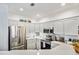 Bright kitchen with modern white cabinets, stainless steel appliances, and ample counter space for cooking and entertaining at 8358 S Independence Cir # 105, Littleton, CO 80128