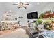 Bright living room with a fireplace, a plush seating area, and view into the kitchen at 8358 S Independence Cir # 105, Littleton, CO 80128