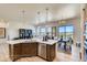 Modern kitchen features a large center island with a sink, stainless steel appliances, and a view to the outside at 935 W 128Th Pl, Westminster, CO 80234