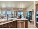 Modern kitchen with a large center island, stainless steel appliances, and an open concept view of the living and dining spaces at 935 W 128Th Pl, Westminster, CO 80234
