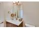 Elegant powder room with a decorative mirror and modern fixtures at 935 W 128Th Pl, Westminster, CO 80234